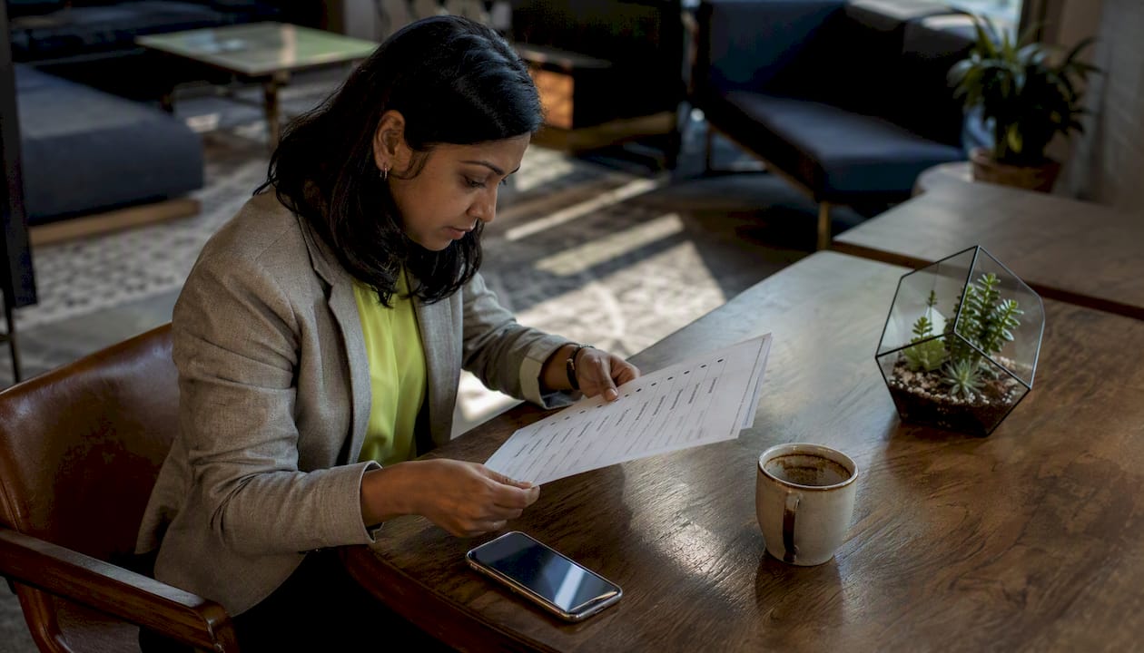 Woman reviewing digital marketing checklist at desk